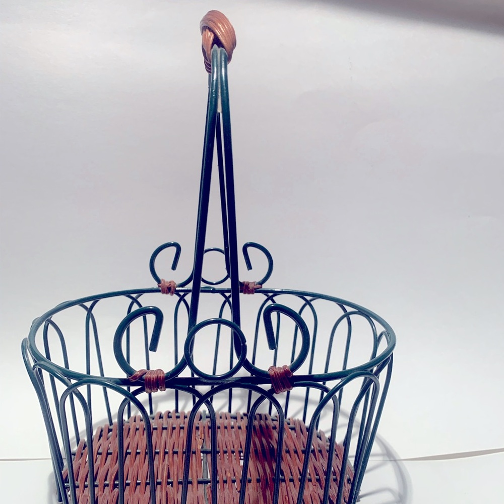 Green wire basket with brown woven bottom